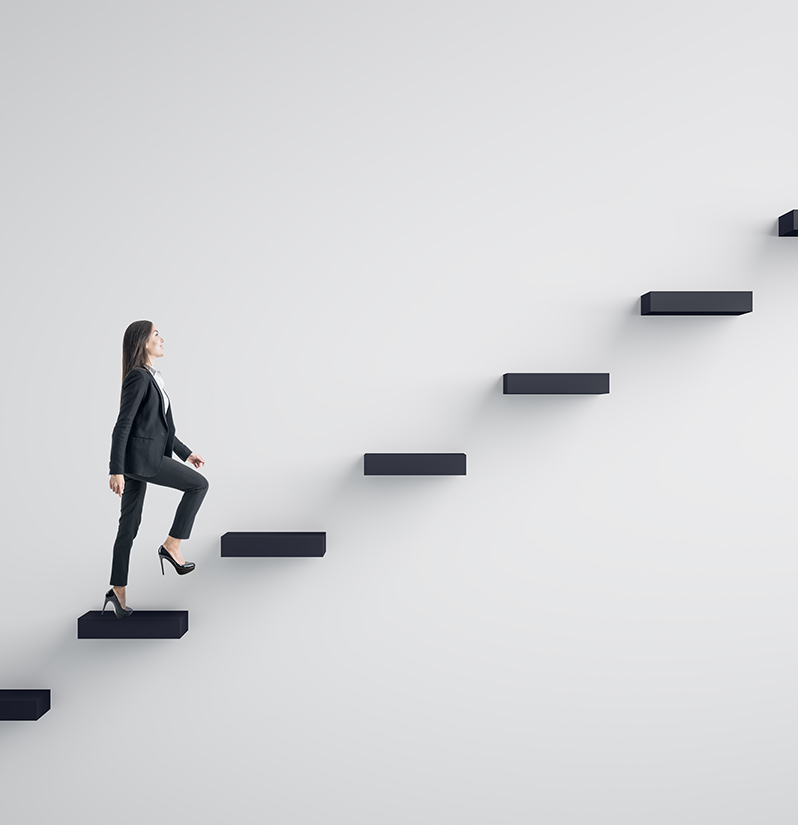 Side view of young businesswoman climbing stair